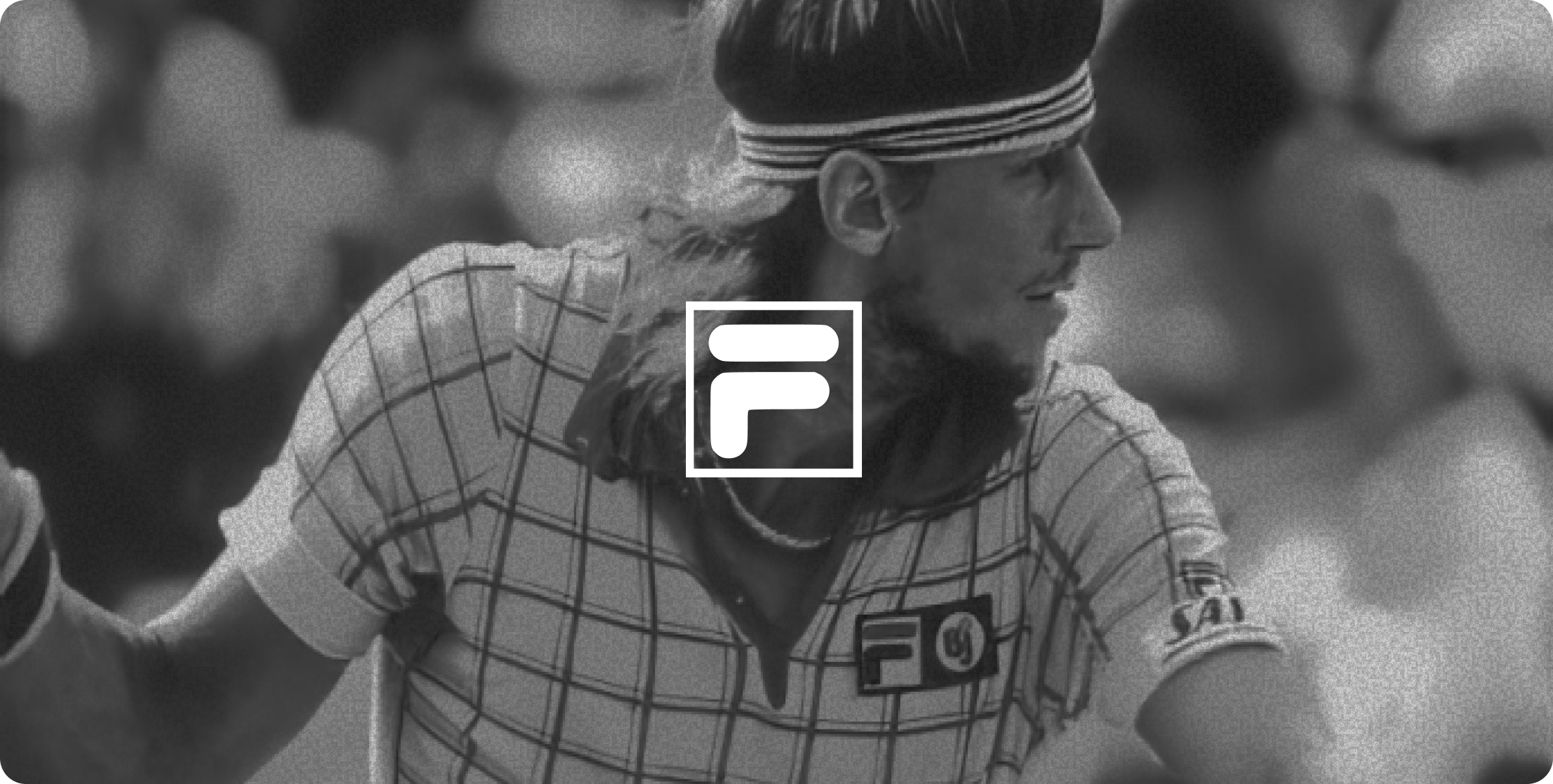 Two women sitting at a modern table talking with a city view behind them.