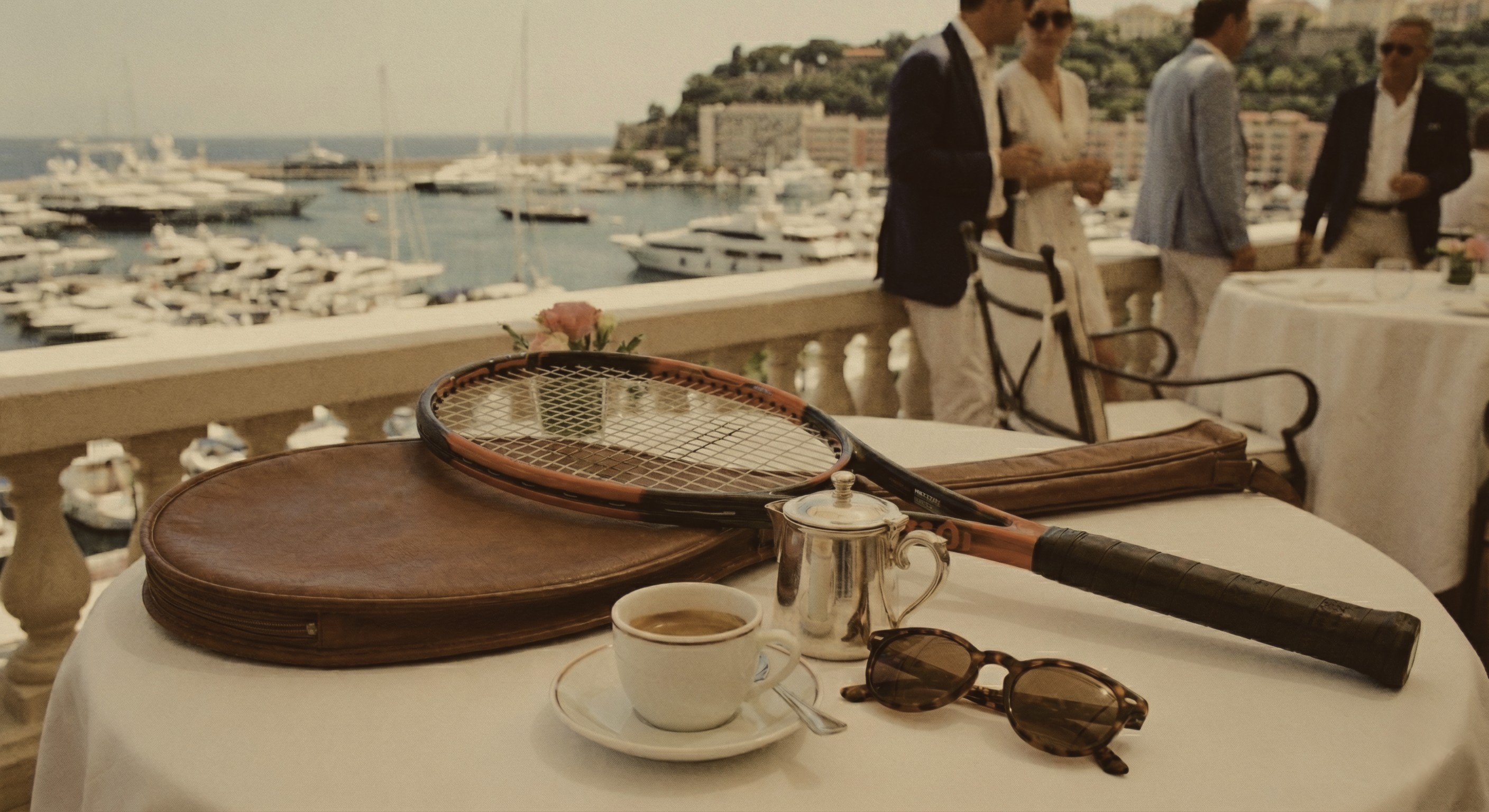 Photo of rows of books in a library with marble busts.
