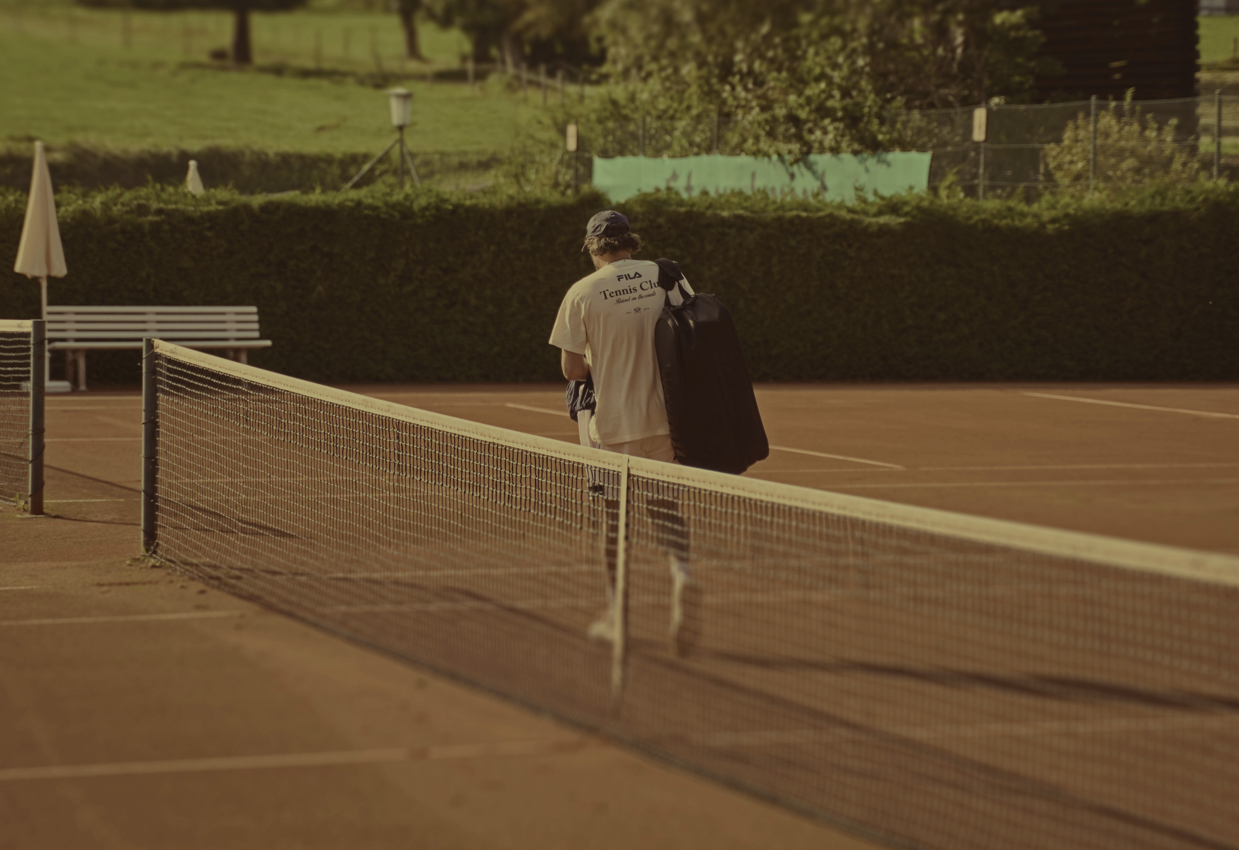 Two women sitting at a modern table talking with a city view behind them.